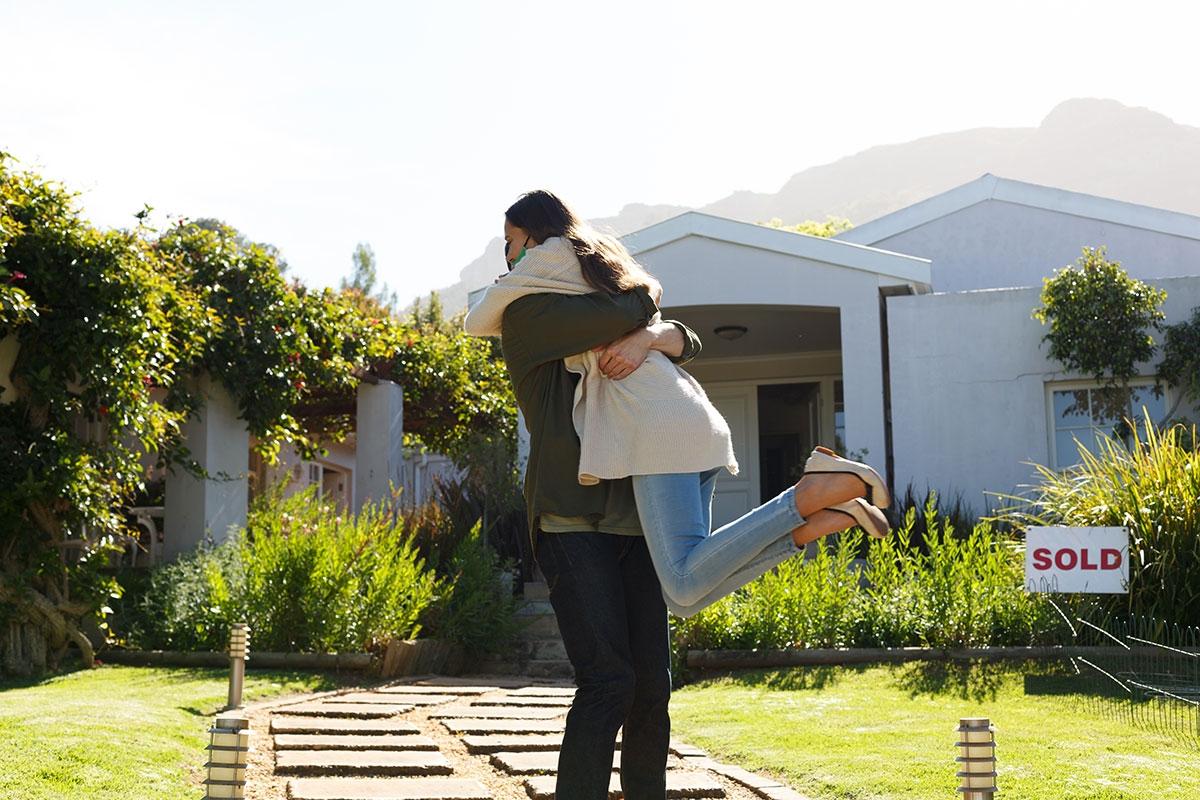 Renters in front of a single-family rental that they bought.