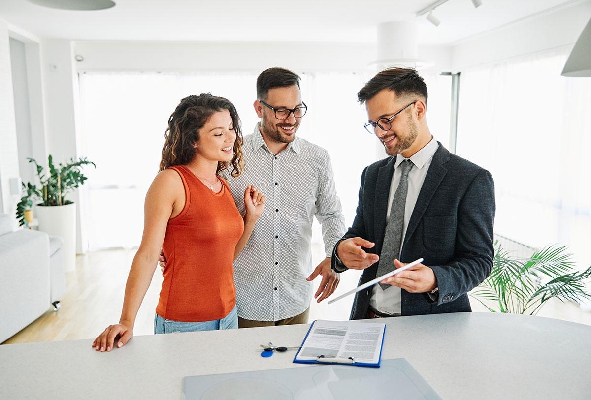 Renters and leasing agent looking at lease.