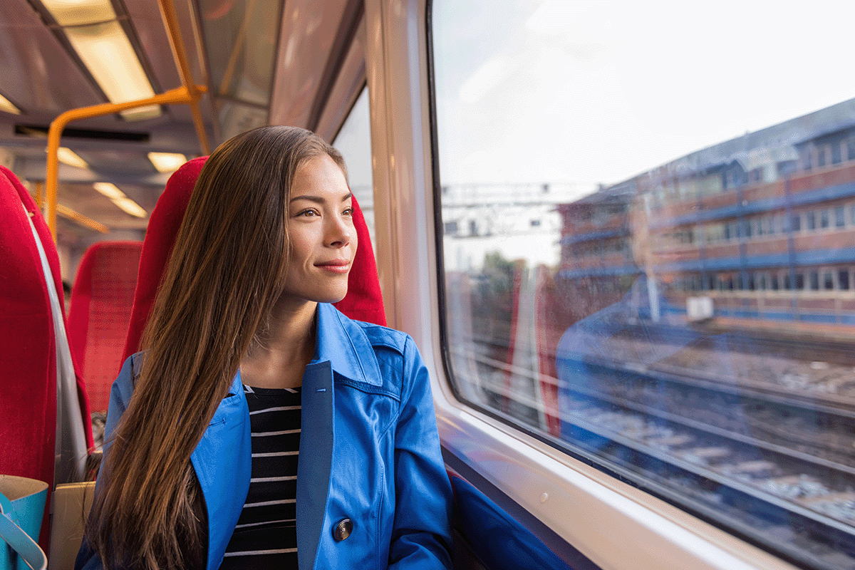 Woman Looking Out Window During Her Subway Commute