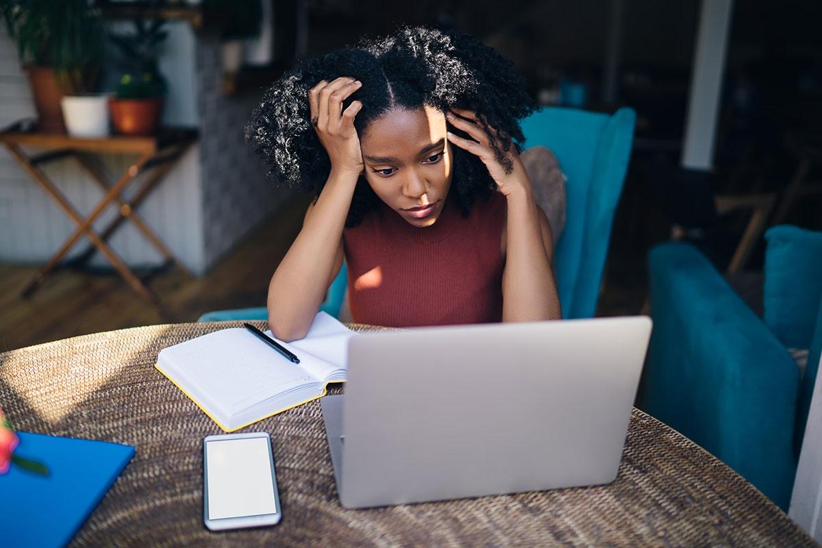 Renter looking at laptop deciding whether to rent in the fall.