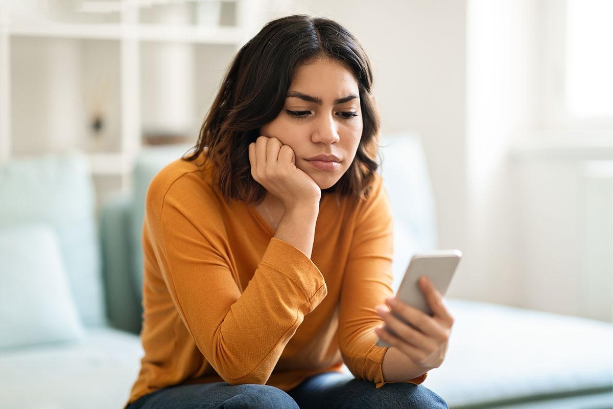 Girl checking her phone and her apartment application status.