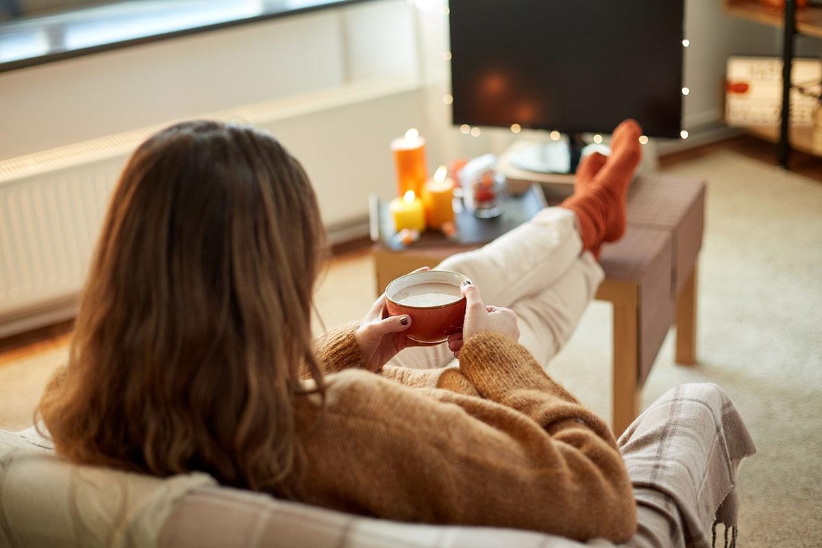 Renter sitting in their fall decorated apartment.