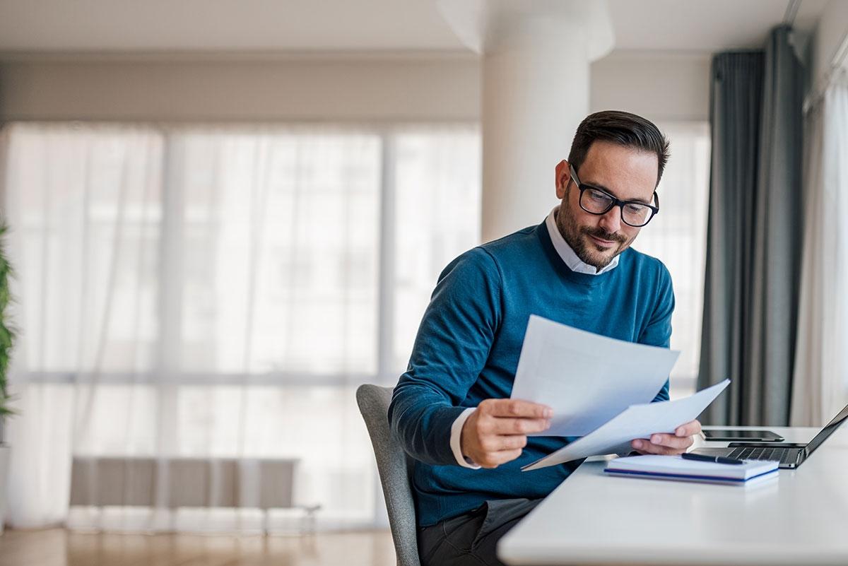 A renter reviewing his papers to see where else he needs to change his address.