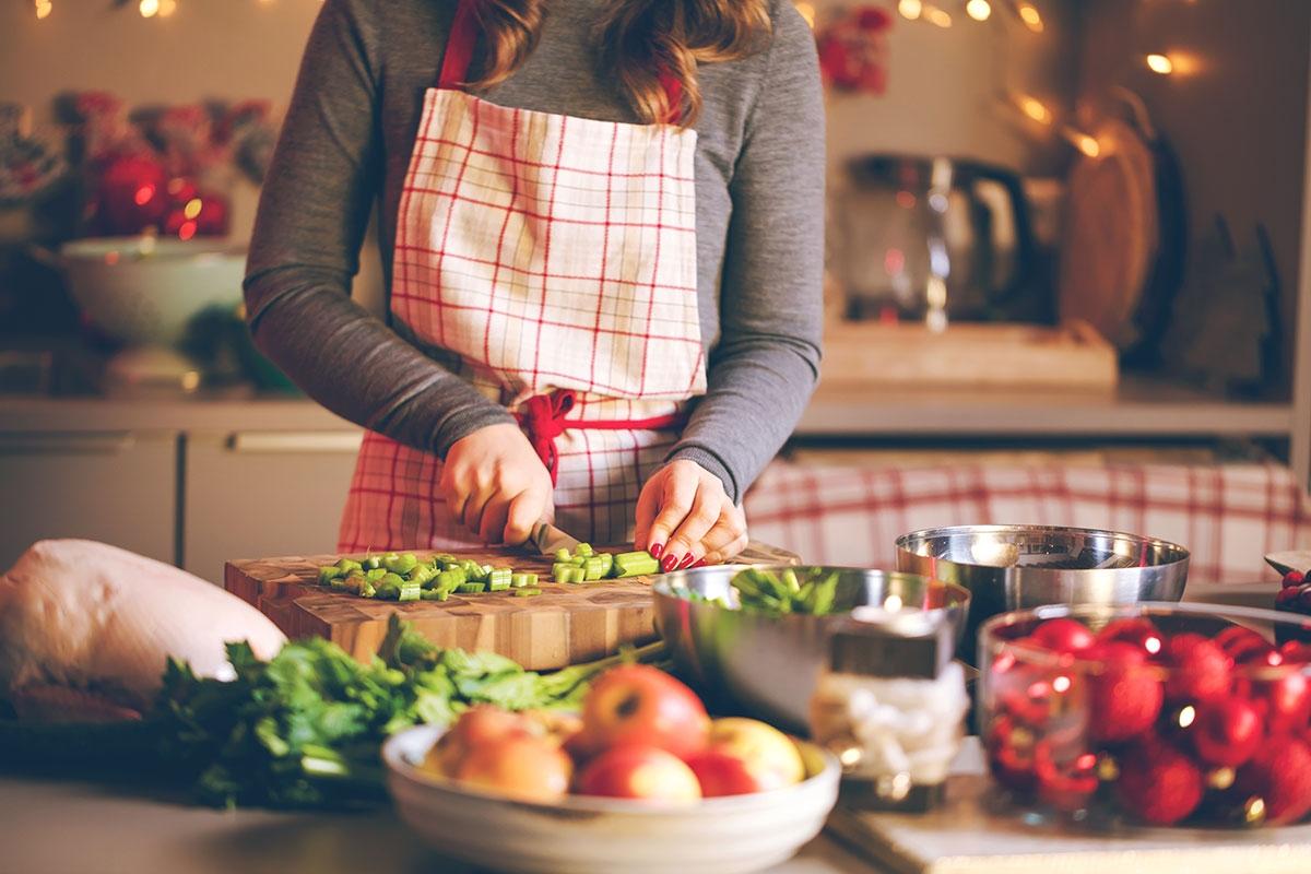 Chopping up vegetables to create a dish for a potluck. 