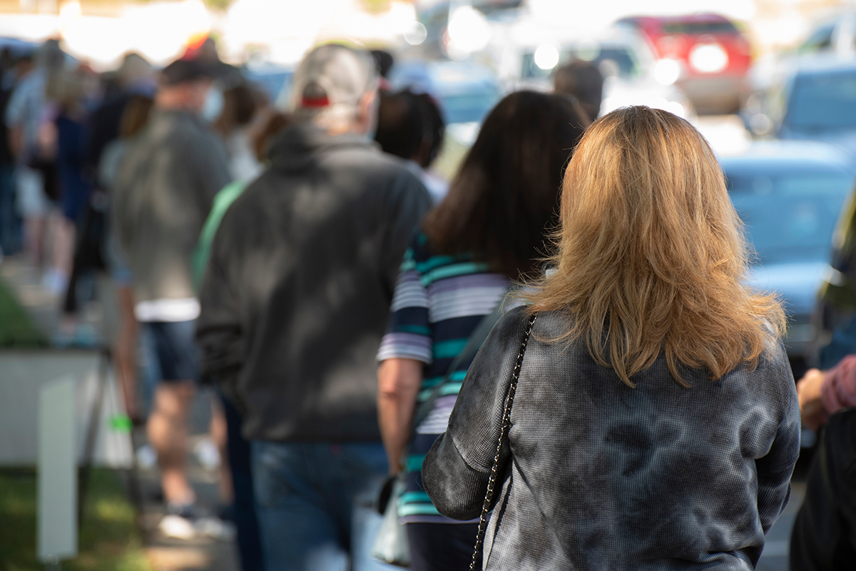 People standing in line at a polling place.