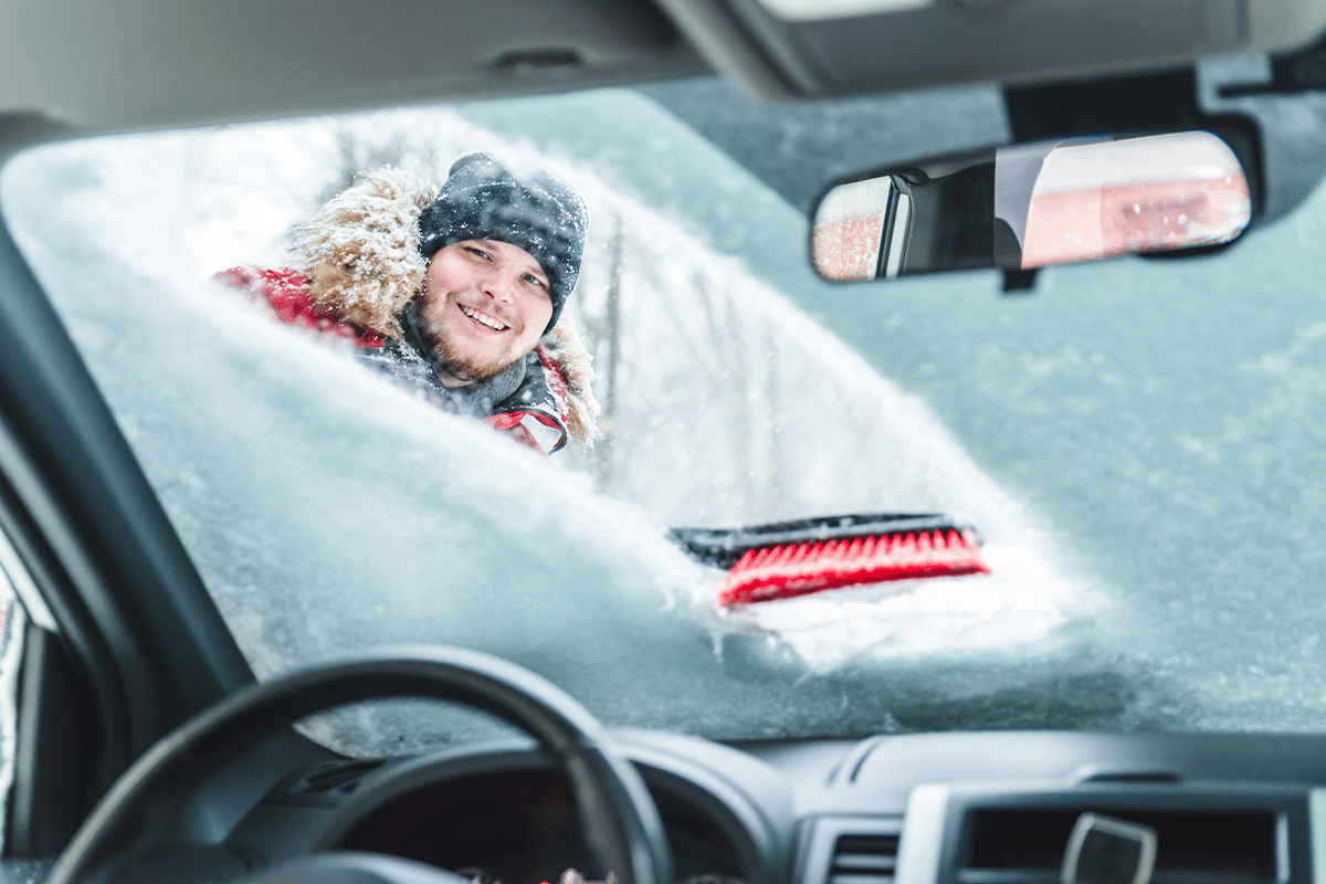 Wiping snow off car