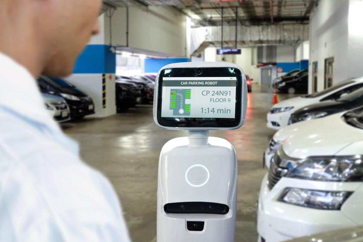 Man using a parking robot to park his car in a garage.
