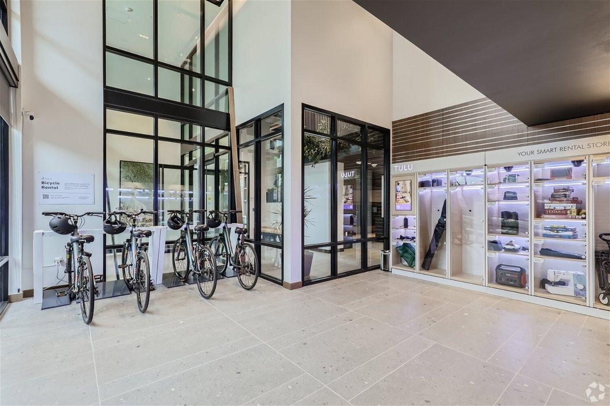 A bike rental and appliance rental station sit in the lobby of an apartment community.