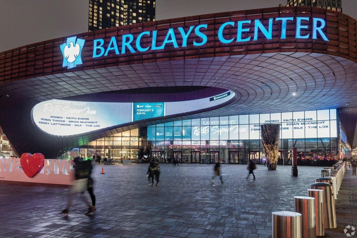 The Barclays Center sign shines blue above its entrance.