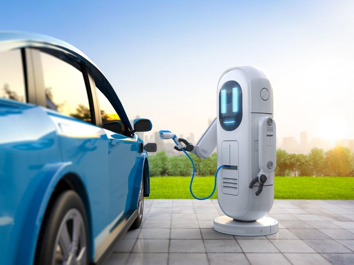 A robot is plugging in an EV to charge it.