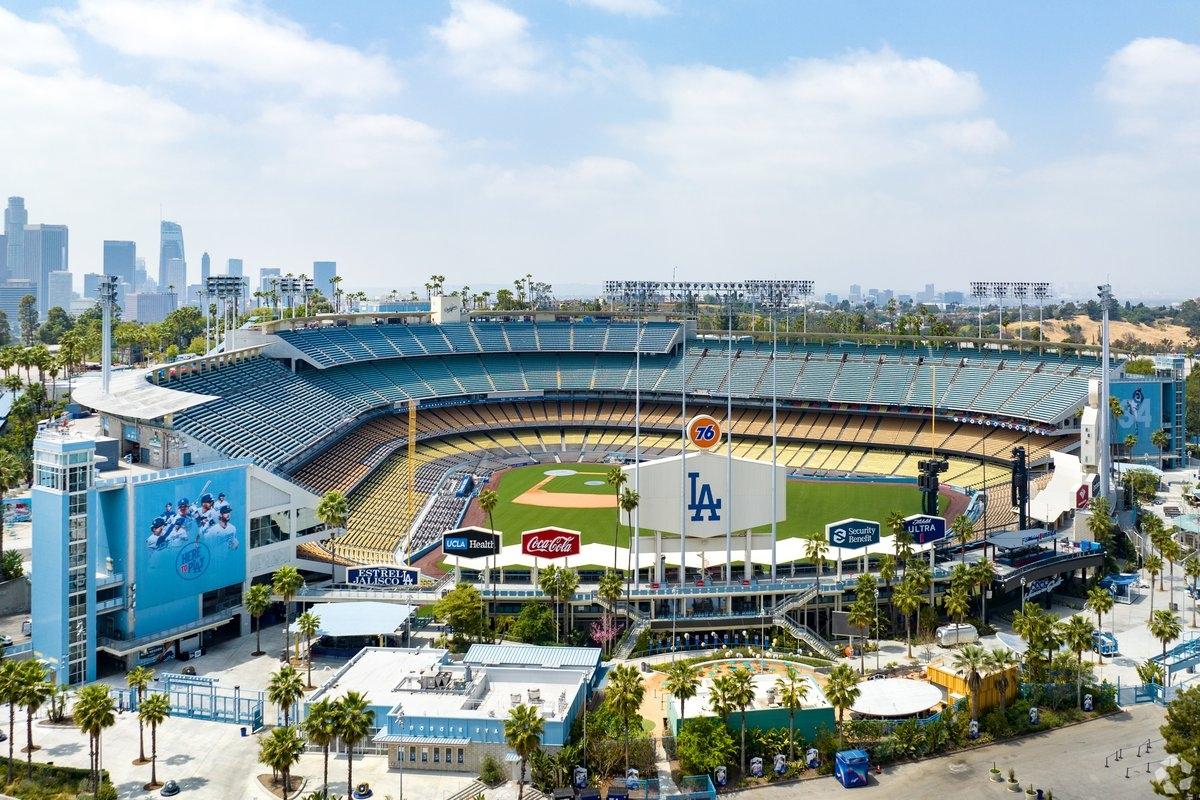 The entrance signs to Dodgers Stadium rise above the field.