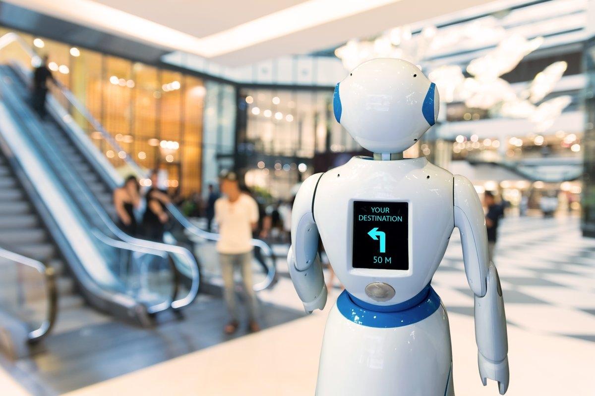 A robot navigates a mall to show a destination.