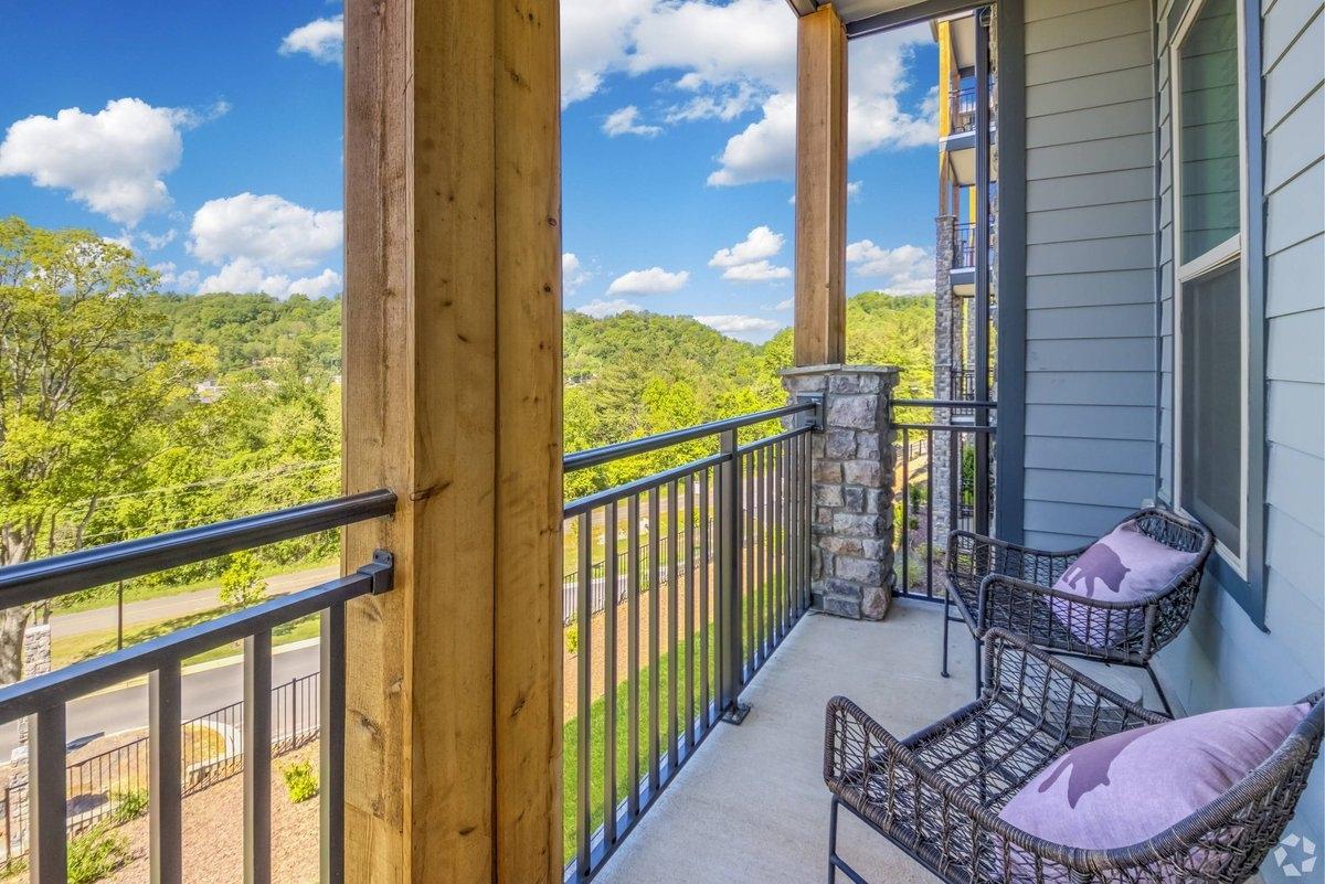 A balcony overlooks the mountains.