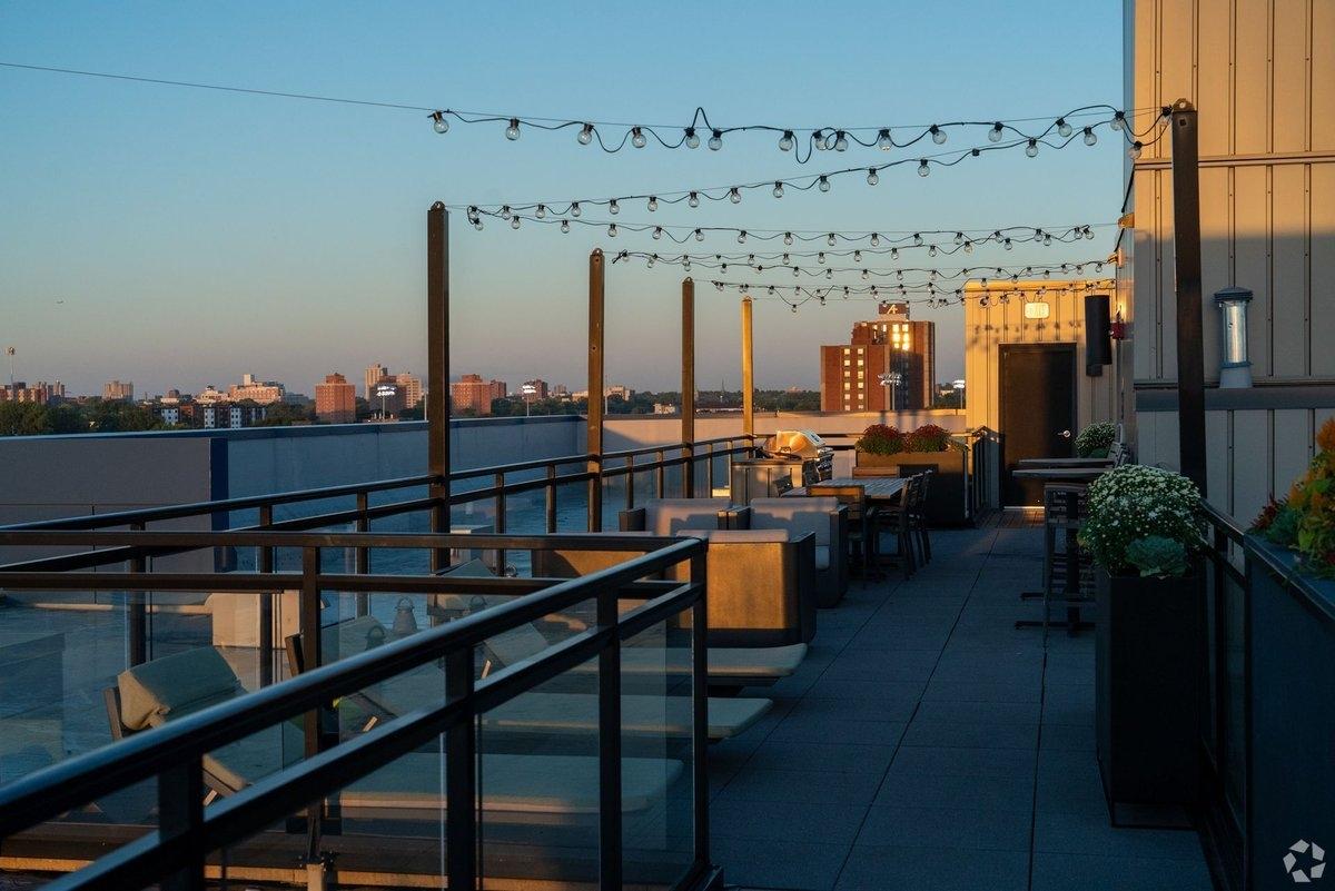 A rooftop deck glows as the sun sets.