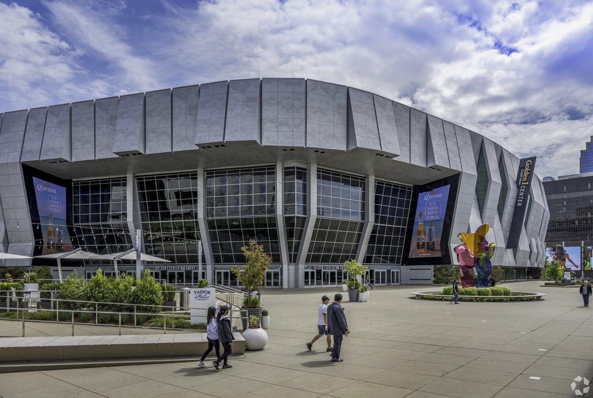 People walk past Golden 1 Center in its entrance plaza.