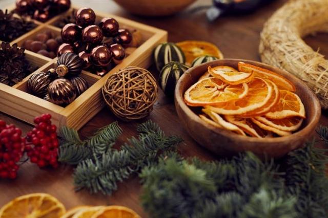 Supplies for making handmade holiday decor, including dried fruits.