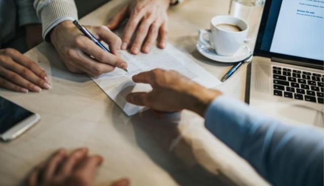 Landlord points to line for renter to sign.