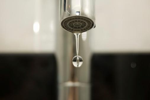 A faucet dripping into the sink