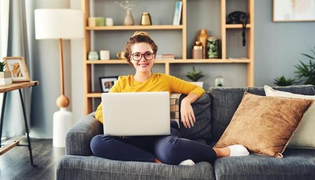 Woman on couch with laptop