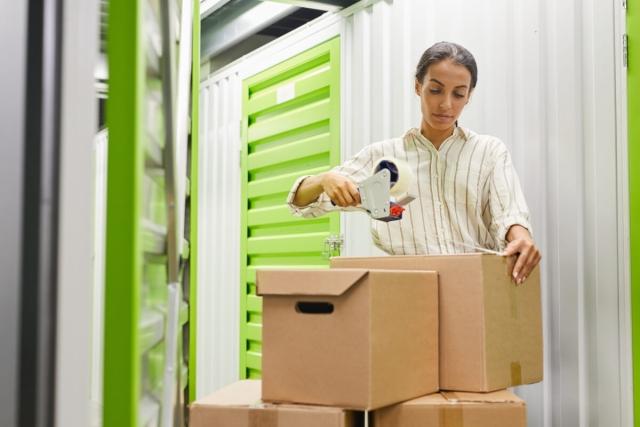 Tenant wraps up boxes to put in her apartment storage unit.
