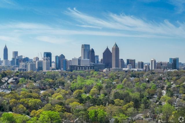 A view of the Atlanta skyline over trees.