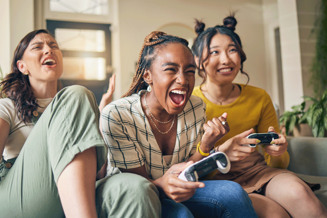 Women gaming together at an apartment game room