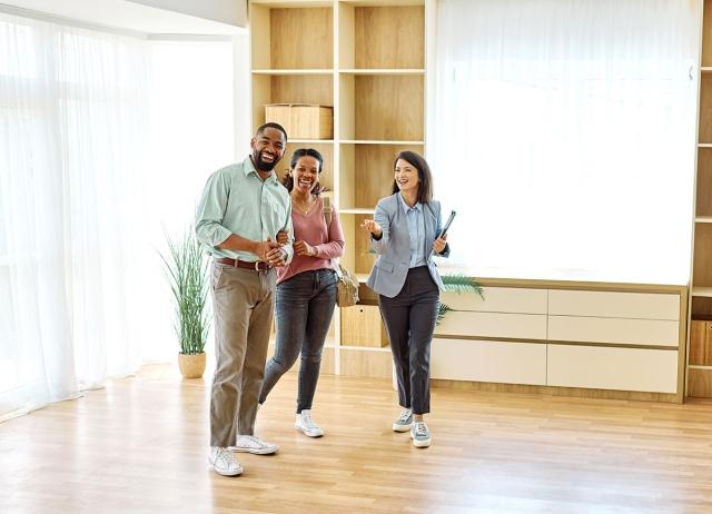 Couple looking at an apartment with a realtor. 