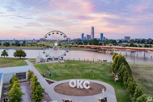Park in Oklahoma City with a ferris wheel and the downtown skyline in the background.