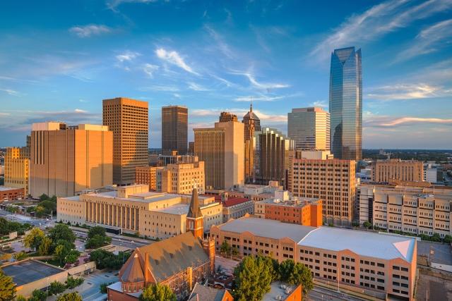 High-rises in Downtown Oklahoma City glow as the sun sets.