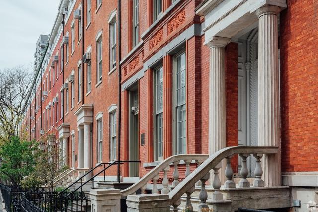 Beautiful brownstones with Greek revival cues line the Washington Square North block in the Greenwich Village neighborhood of Manhattan.