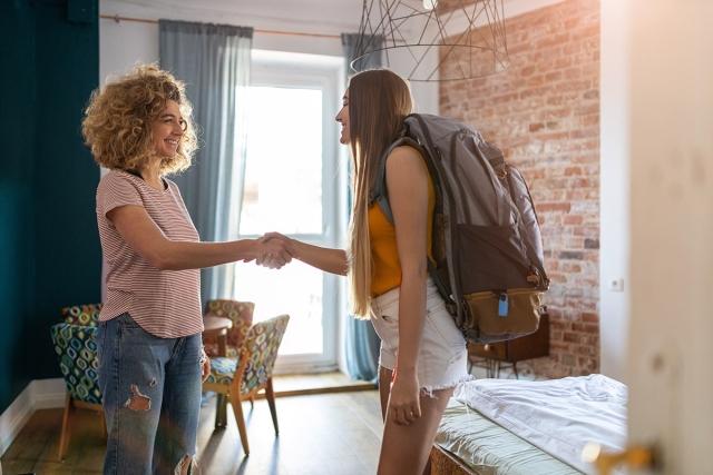 Traveler and landlord shaking hands.