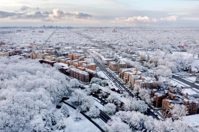 Suburbs of Detroit are covered in a blanket of snow with the city way in the background.