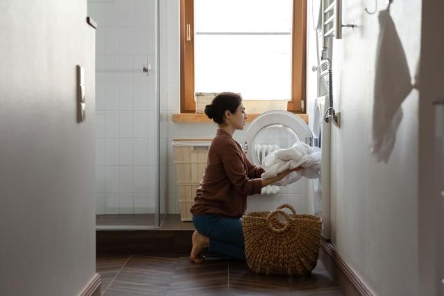 Renter doing laundry in her apartment.