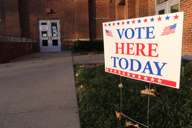 A sign outside a polling place reads "Vote Here Today."