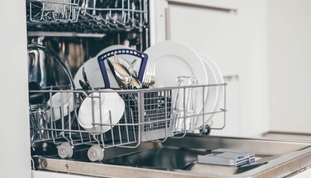 An open dishwasher filled with clean dishes.