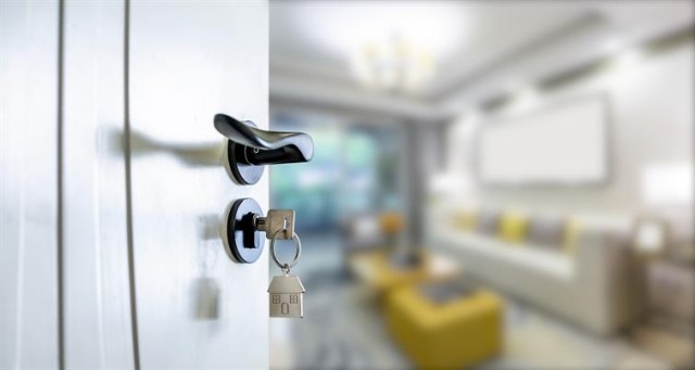Looking into an apartment, the focus on a key in the lock