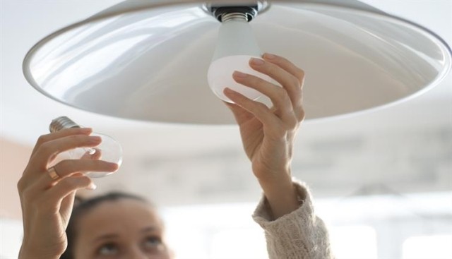 an image of a renter changing a lightbulb