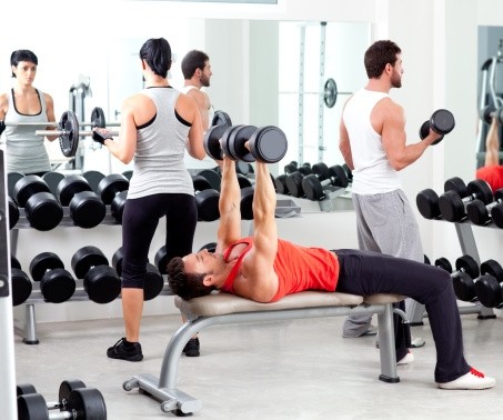 Three people working out in an apartment gym