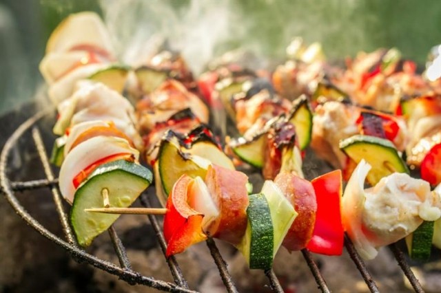 Steaming kebabs on a grill