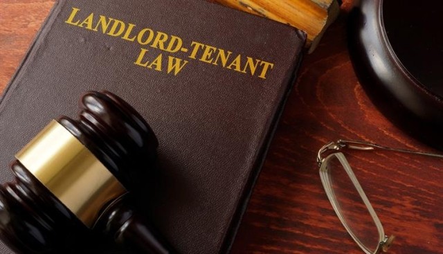 A gavel resting on a book of landlord-tenant law.