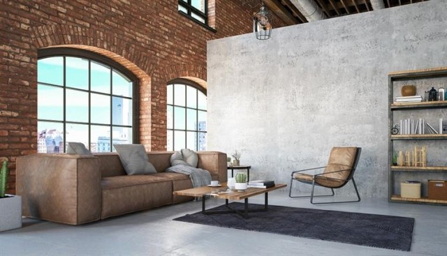 A loft apartment with exposed brick and large windows.