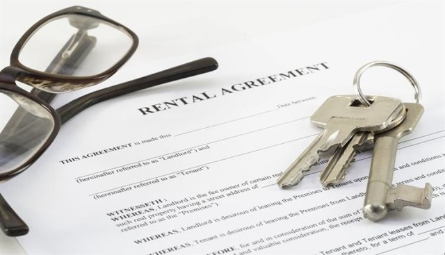A paper copy of a rental agreement and house keys