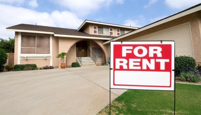 A for rent sign outside of a single family home