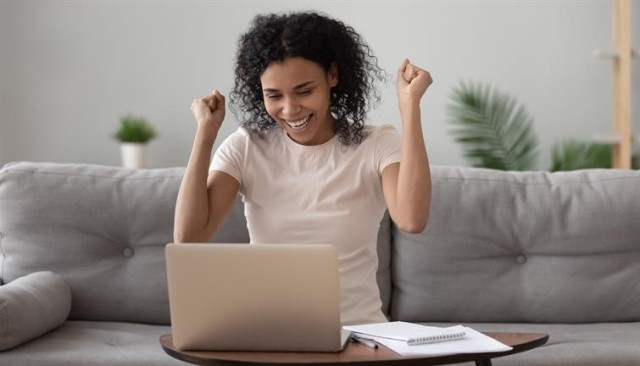 Elated woman signing a lease online.