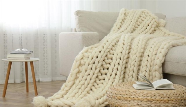 A cozy throw sitting on a couch