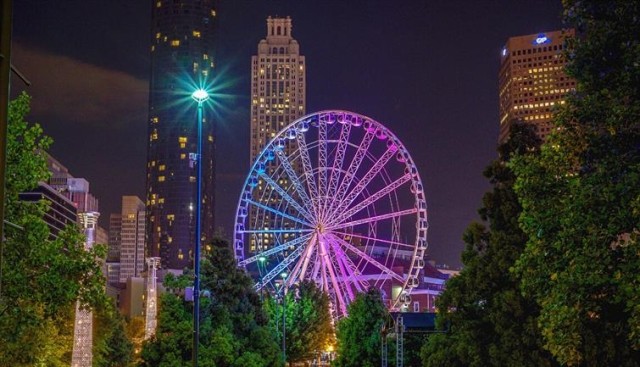 SkyView Atlanta, a downtown Ferris wheel, lit up at night.