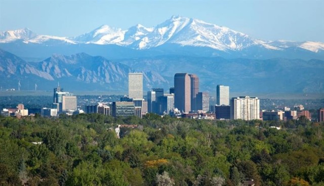 Downtown Denver against snow-capped mountains.