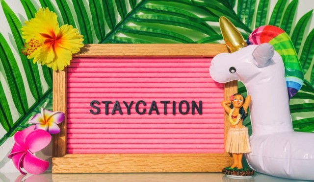 An image of a sign that says "Staycation."
