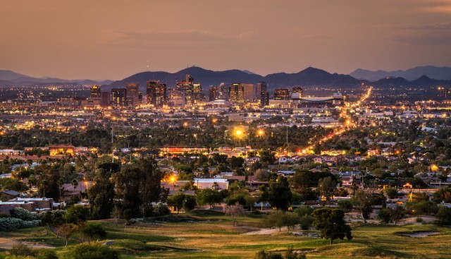 The skyline of Phoenix, Arizona, at sunset with mountains in the background