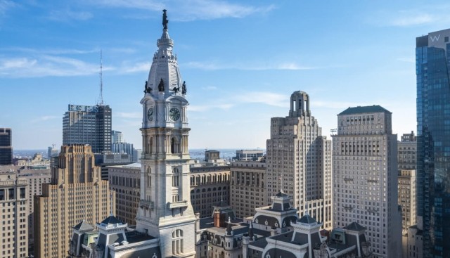 The statue of William Penn at the top of Philadelphia City Hall towers over the Philadelphia skyline.